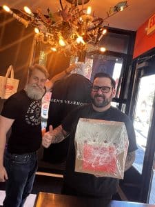 A Whipped Bakeshop groom picking up his wedding cake